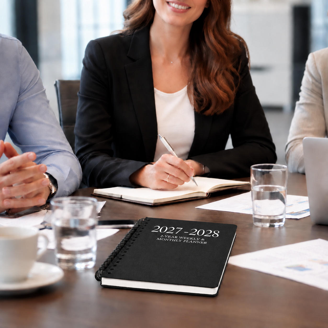 2027–2028 spiral planner on a conference table during a professional business meeting 