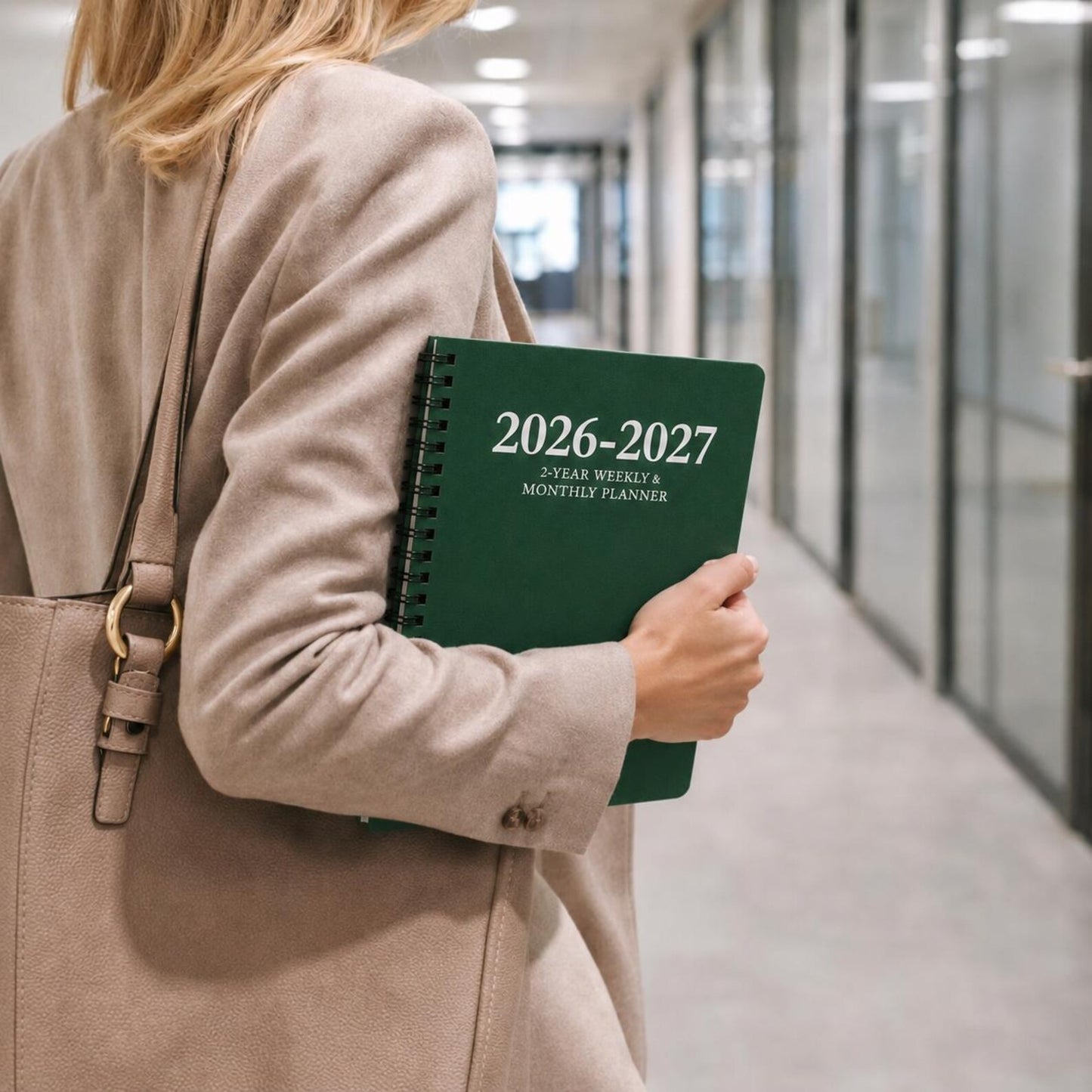Woman carrying green 2026 2027 spiral planner for meetings work school daily planning and organization